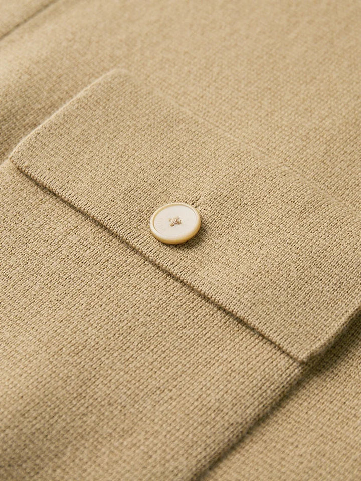 Detail shot of polo cardigan ribbed cuffs and waistband with structured knit construction