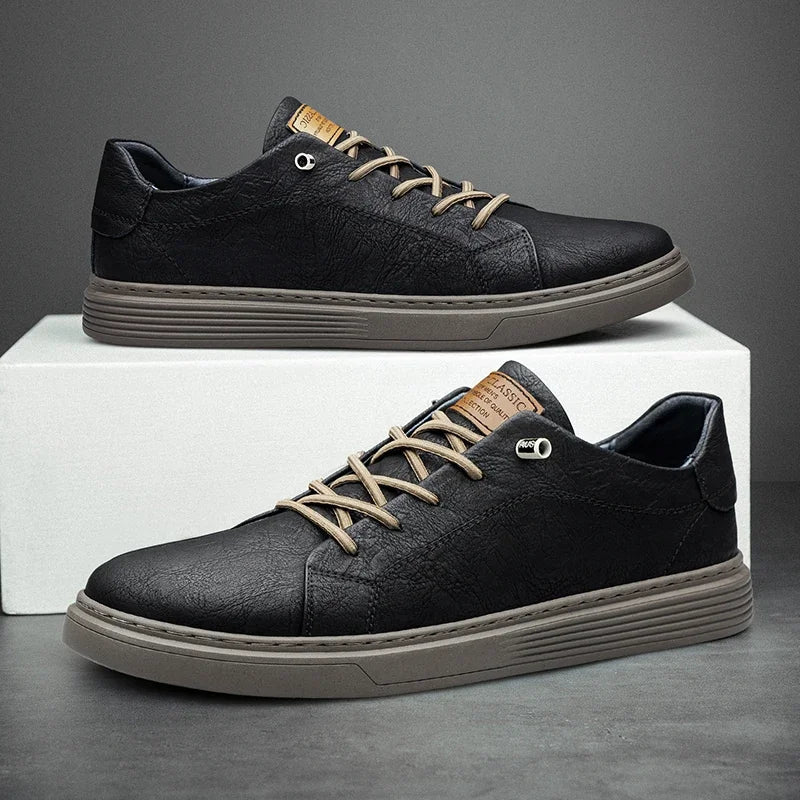 Side view of men's black textured sneakers with contrast tan accents and padded collar