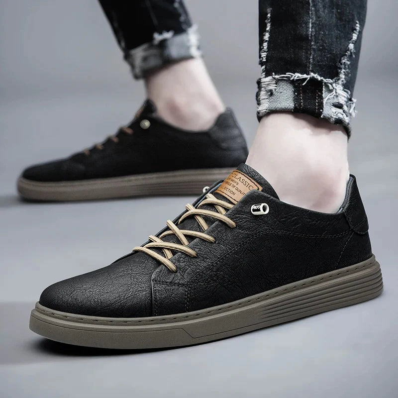Men's low-top sneakers detail shot highlighting padded ankle collar and smooth finish