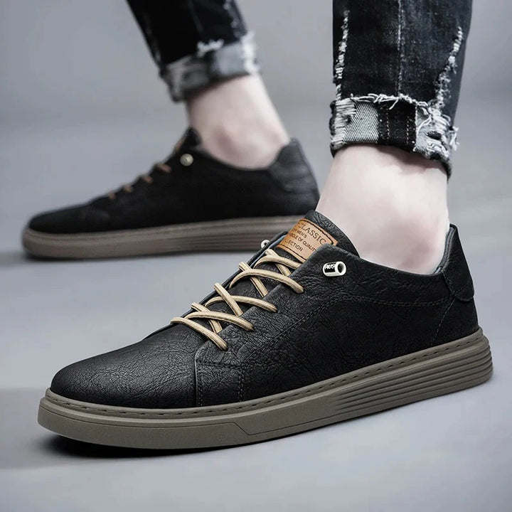 Men's low-top sneakers detail shot highlighting padded ankle collar and smooth finish