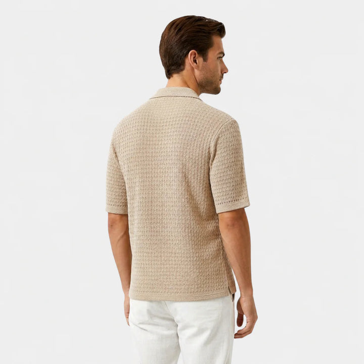 Side view of men's beige short sleeve shirt displaying relaxed fit and camp collar style