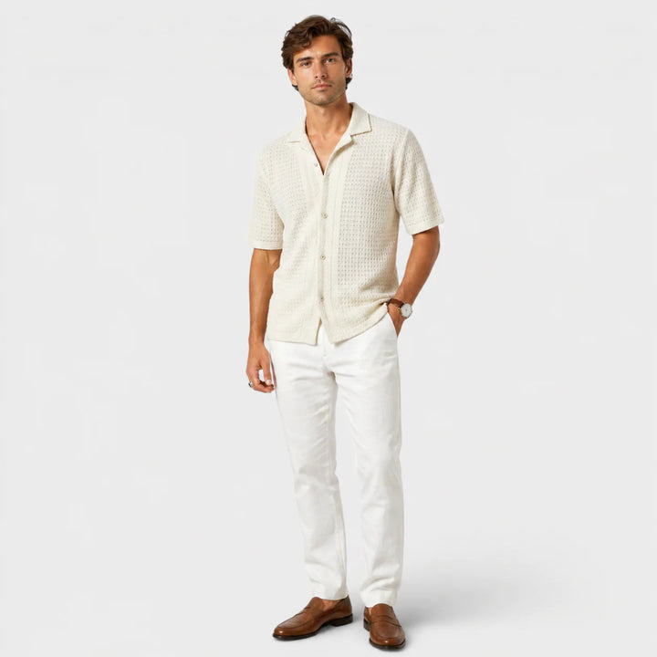 Men's beige camp collar shirt flat lay showing short sleeves and button-front design