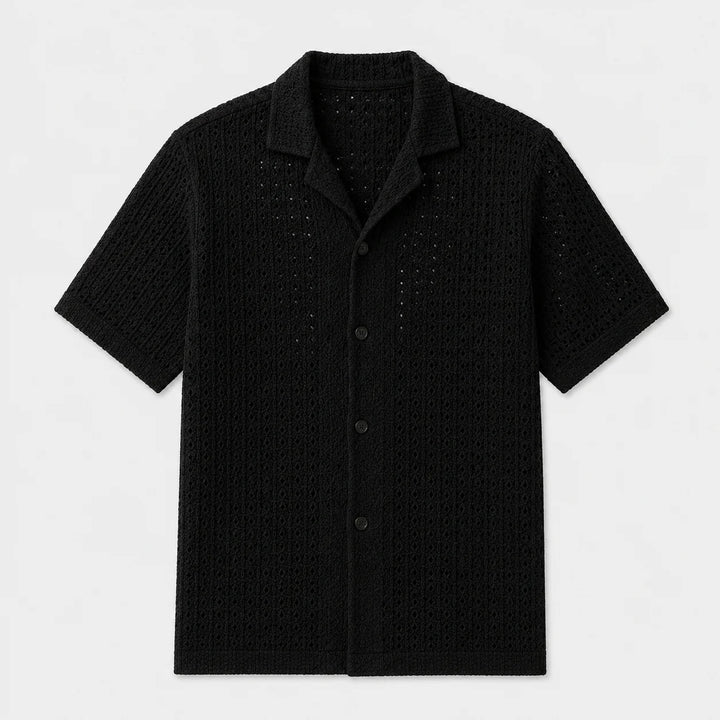 Close-up of textured knit fabric on men's short sleeve shirt showing structured weave pattern