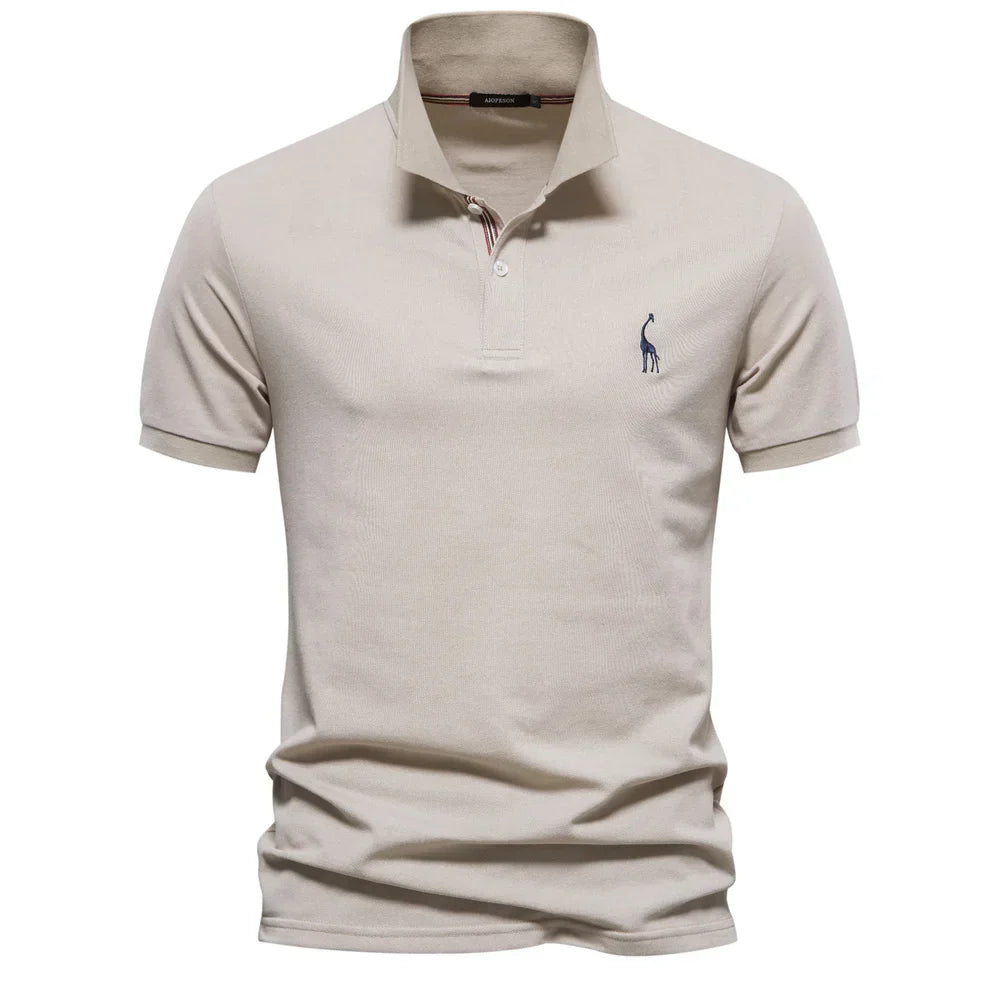 Close-up of embroidered chest logo on men's short-sleeve polo shirt with pointed collar