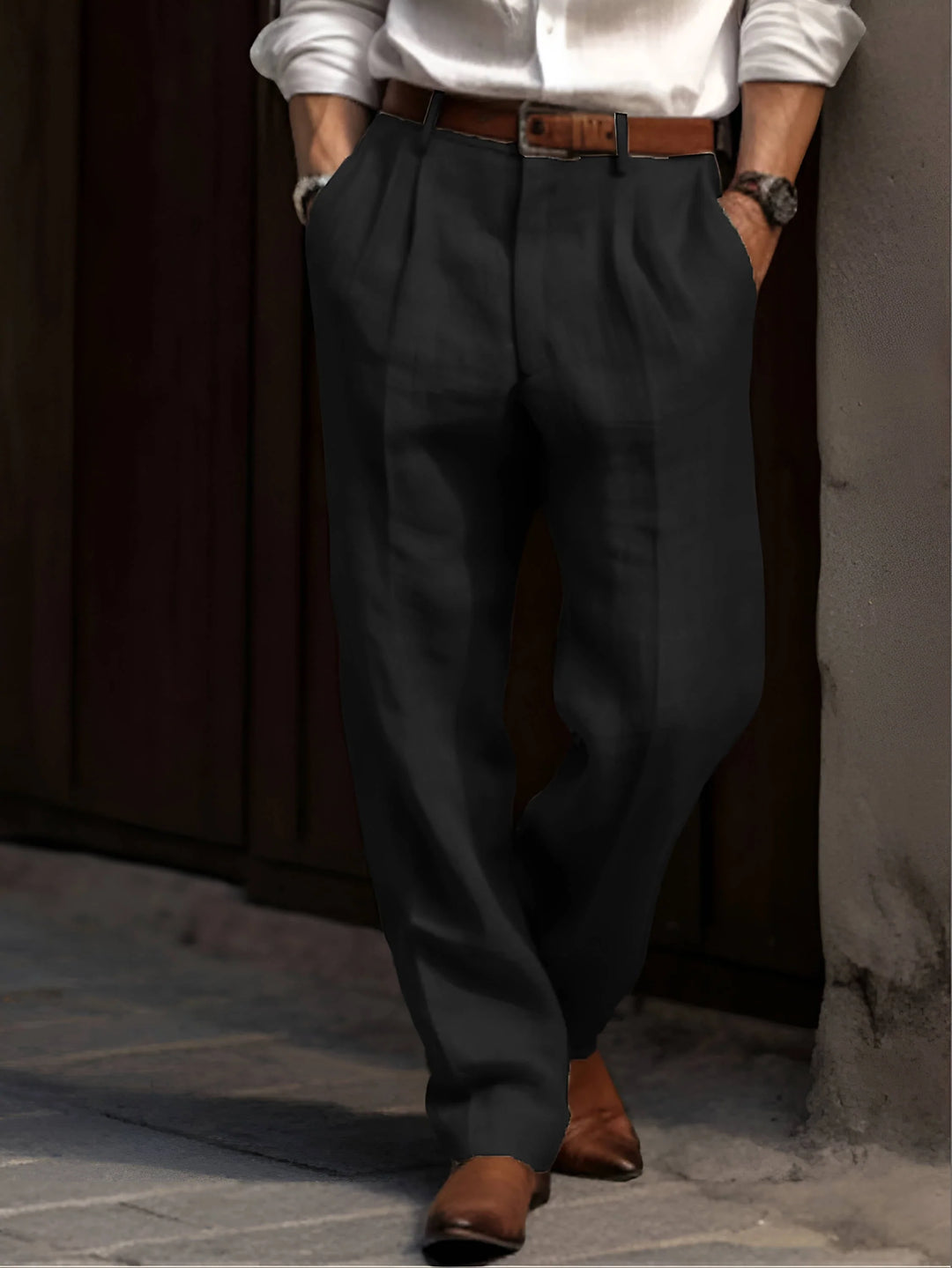 Front detail of men's pleated pants featuring elastic waistband and belt loops