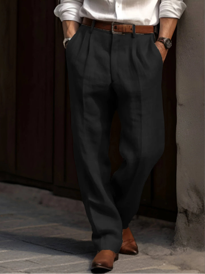 Front detail of men's pleated pants featuring elastic waistband and belt loops