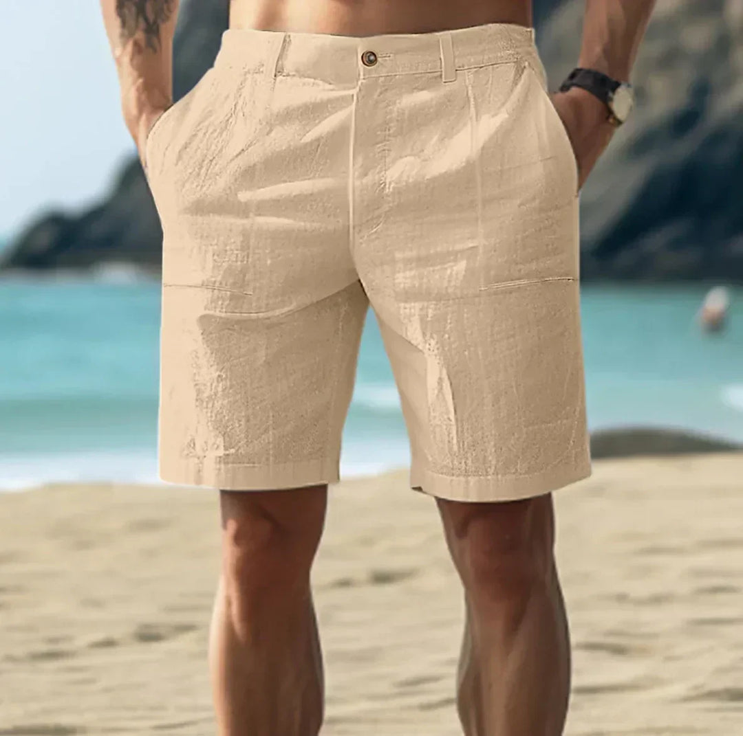 Close-up of men's relaxed chino shorts button closure and woven fabric texture in white