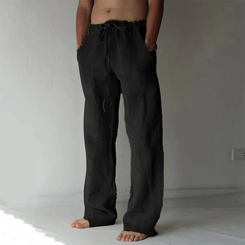 Side angle of men's relaxed pants with drawstring waistband and airy fabric drape