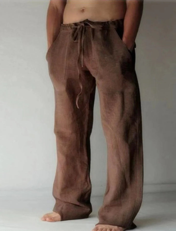 Detail of men's wide-leg pants featuring adjustable drawstring closure and functional side pockets