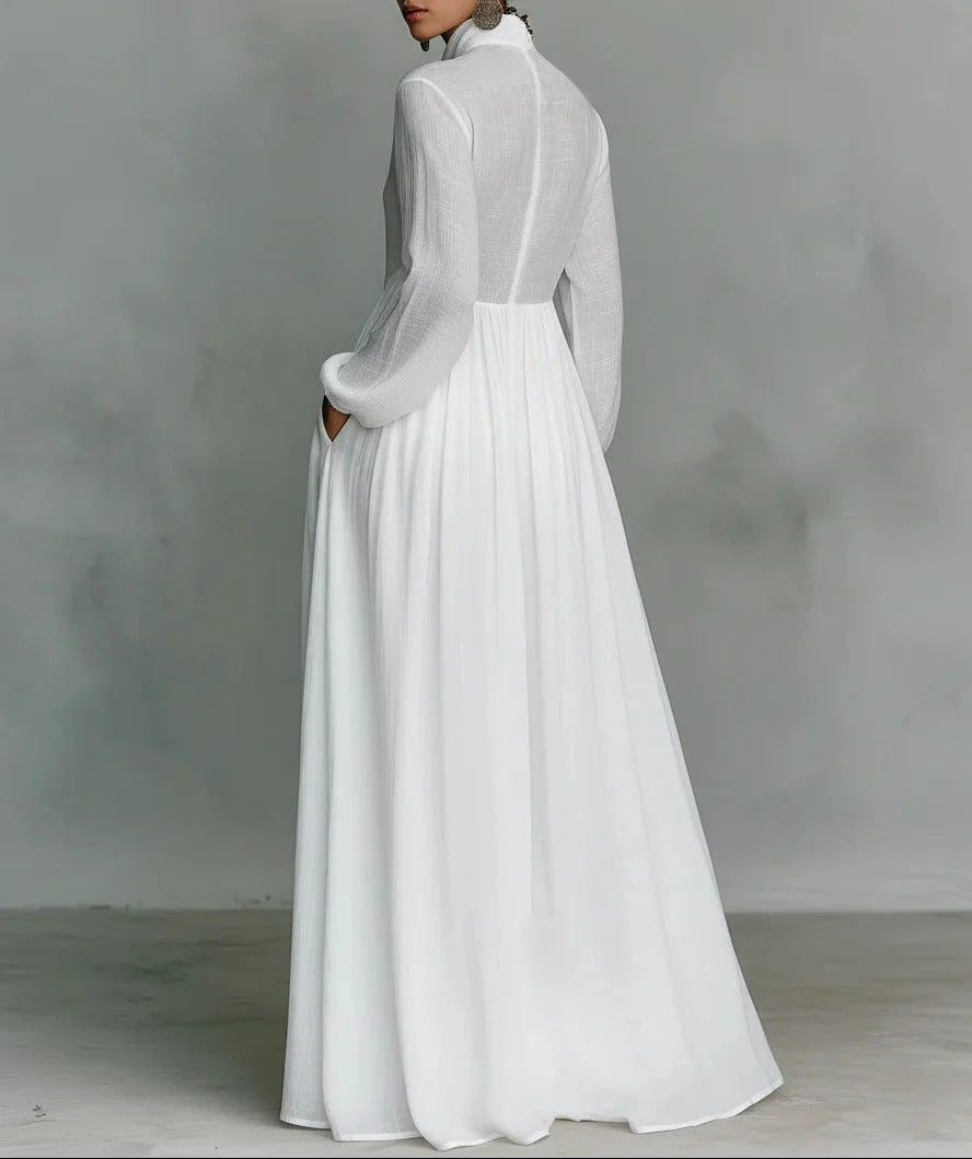 Side view of white button-front maxi dress showing defined waist, gathered skirt, and full-length silhouette