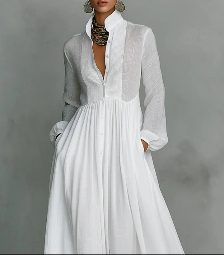Close-up detail of button placket and stand collar on white maxi dress with lightweight fabric