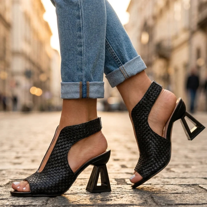 Women's lightweight open toe heels styled with rolled denim jeans on city street