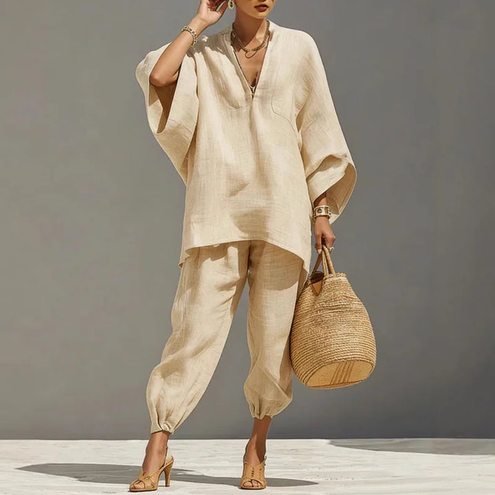 Side angle of women's linen matching set highlighting oversized top and tapered pant silhouette