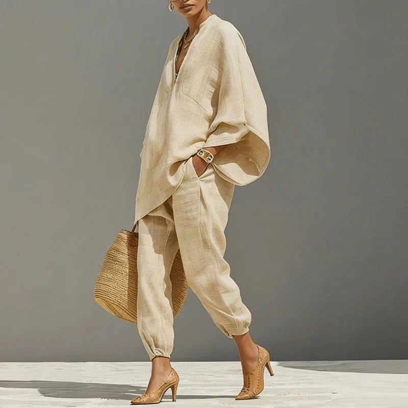 Full-length view of beige linen two-piece set styled with woven accessories