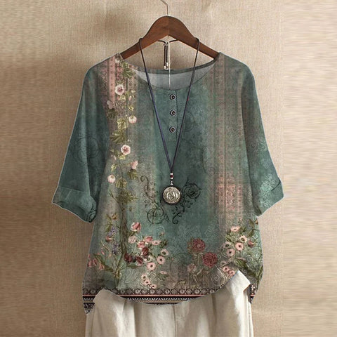 Women's floral print blouse with vintage botanical pattern and relaxed short sleeve design on hanger