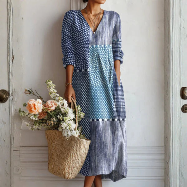 Woman wearing a navy and white linen midi dress with mixed geometric prints and V-neckline