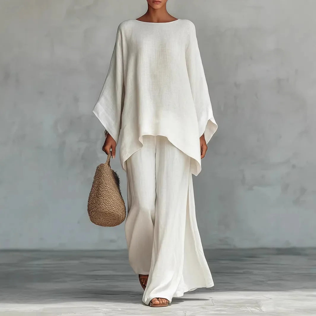 Women's linen two piece set with oversized top and wide leg pants in white featuring asymmetrical hemline