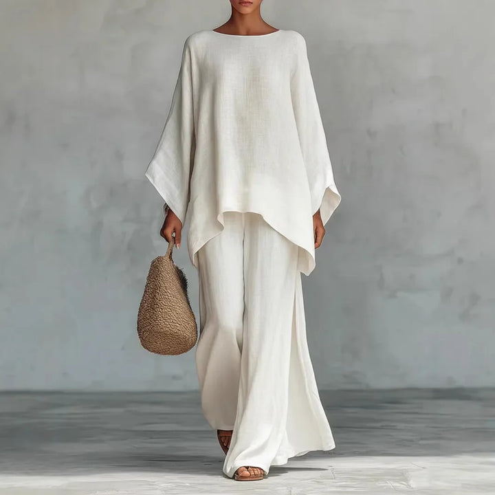 Women's linen two piece set with oversized top and wide leg pants in white featuring asymmetrical hemline