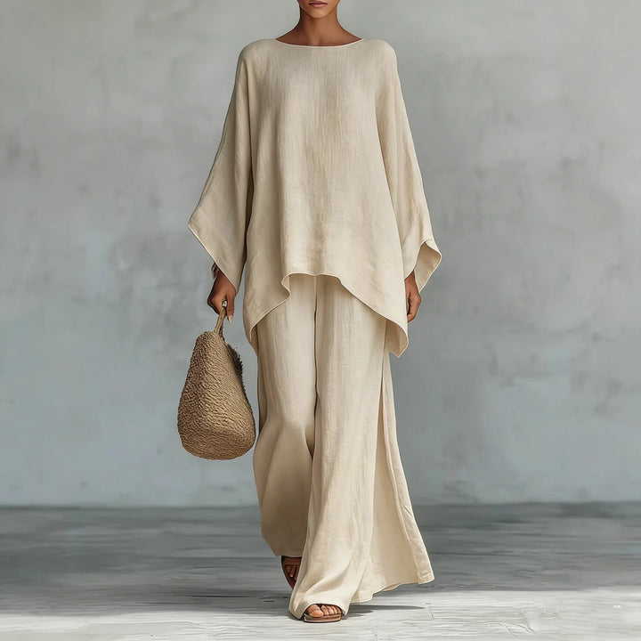 Detail of asymmetrical hemline on oversized linen top paired with wide leg trousers