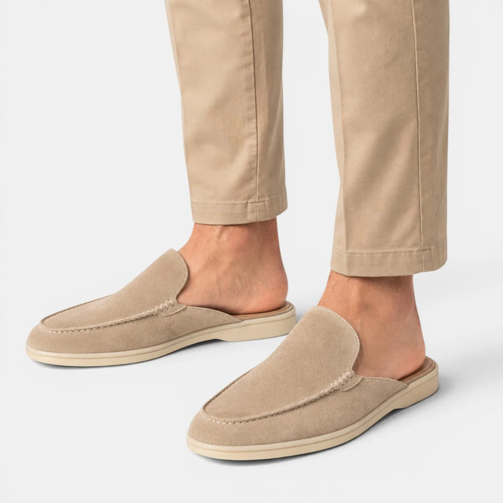 Close-up of men's backless mules featuring smooth interior lining and cushioned footbed construction