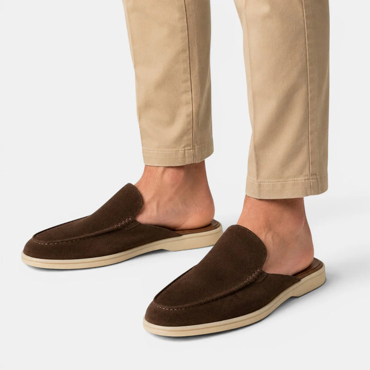 Men's slip-on mules in beige displayed on neutral background highlighting minimalist loafer style