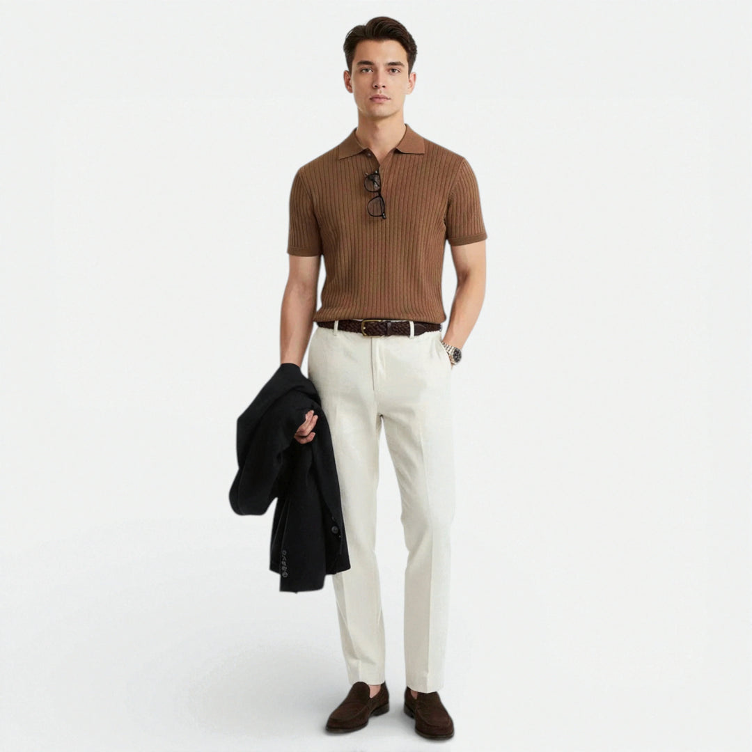 Side angle of men's short sleeve polo with structured knit fabric and ribbed detailing throughout