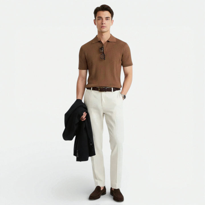 Side angle of men's short sleeve polo with structured knit fabric and ribbed detailing throughout