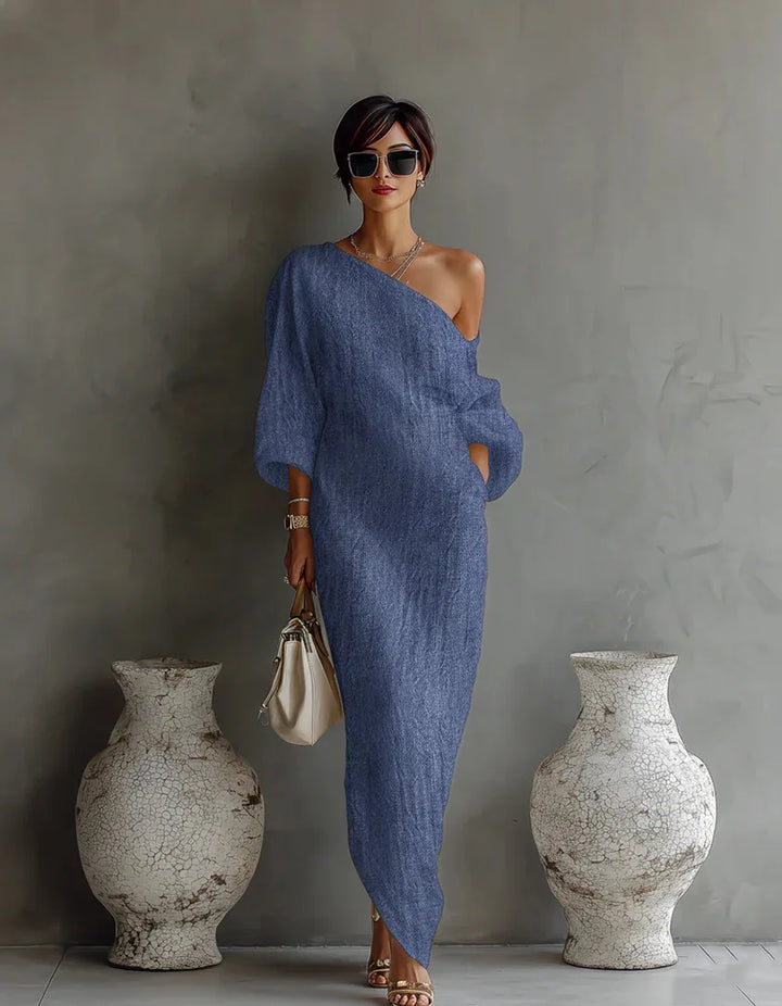 Full-length view of white maxi one shoulder dress styled with sandals and handbag for summer occasions