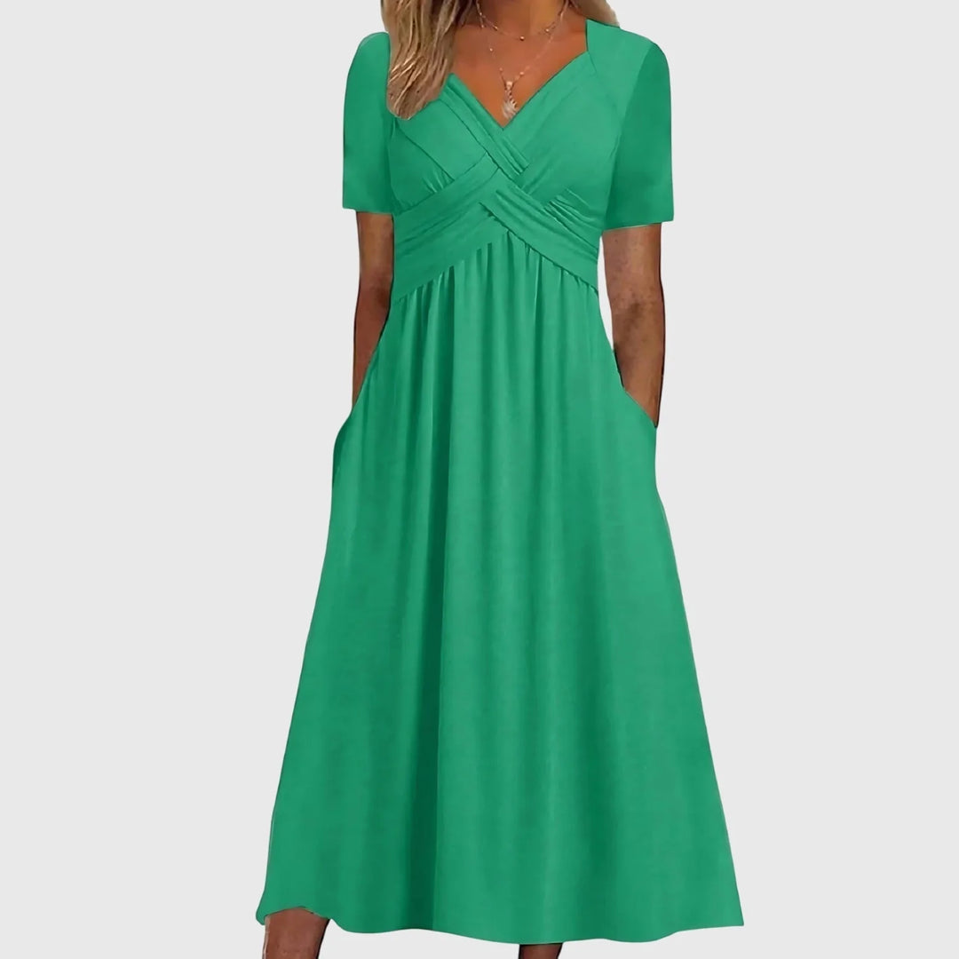Green midi dress with tummy control featuring crossover bodice and V-neckline on model