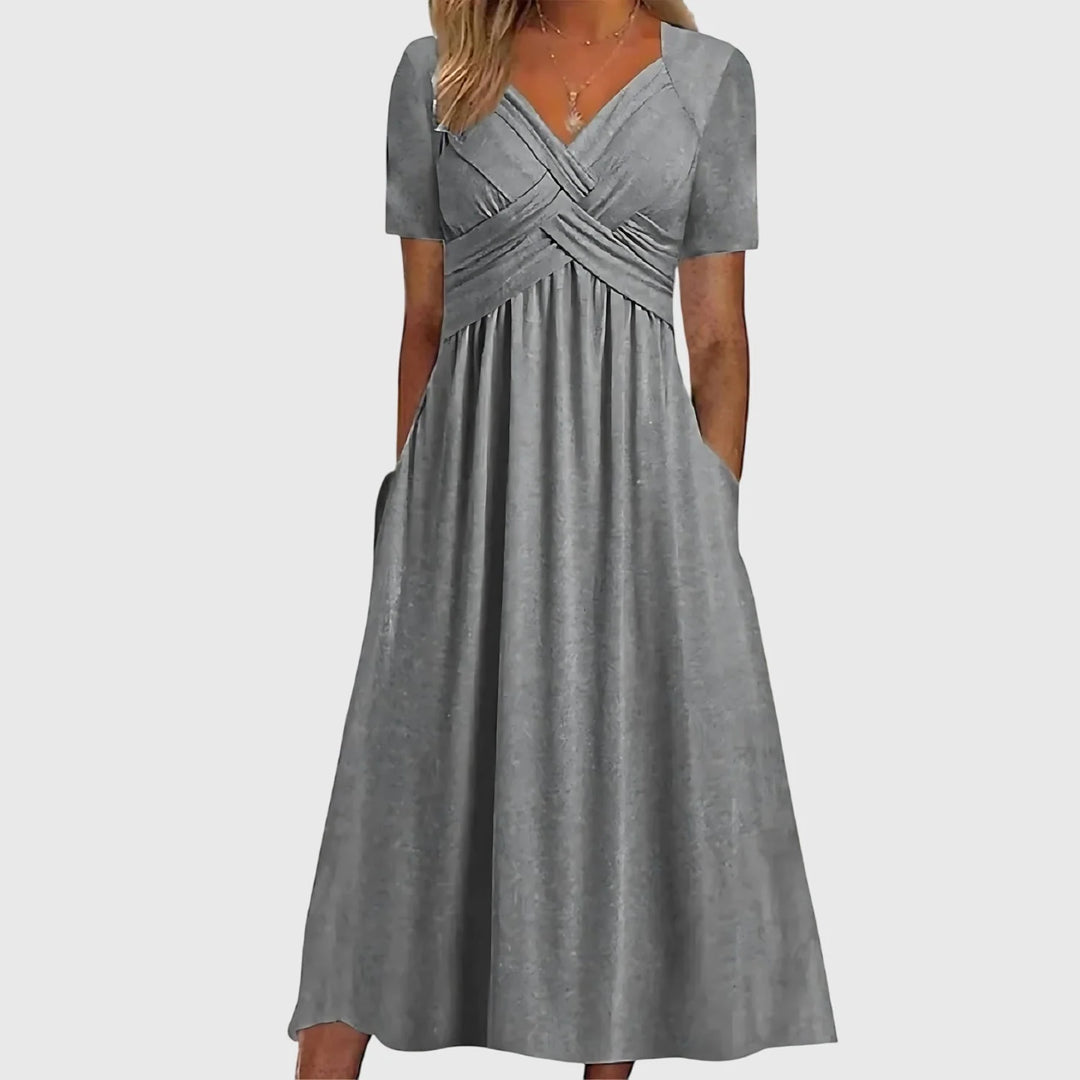 Side angle of crossover bodice midi dress with tummy control and functional pockets