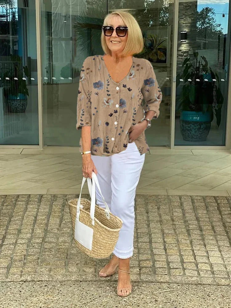 Women's floral V-neck blouse with three-quarter sleeves and button-front placket in taupe.