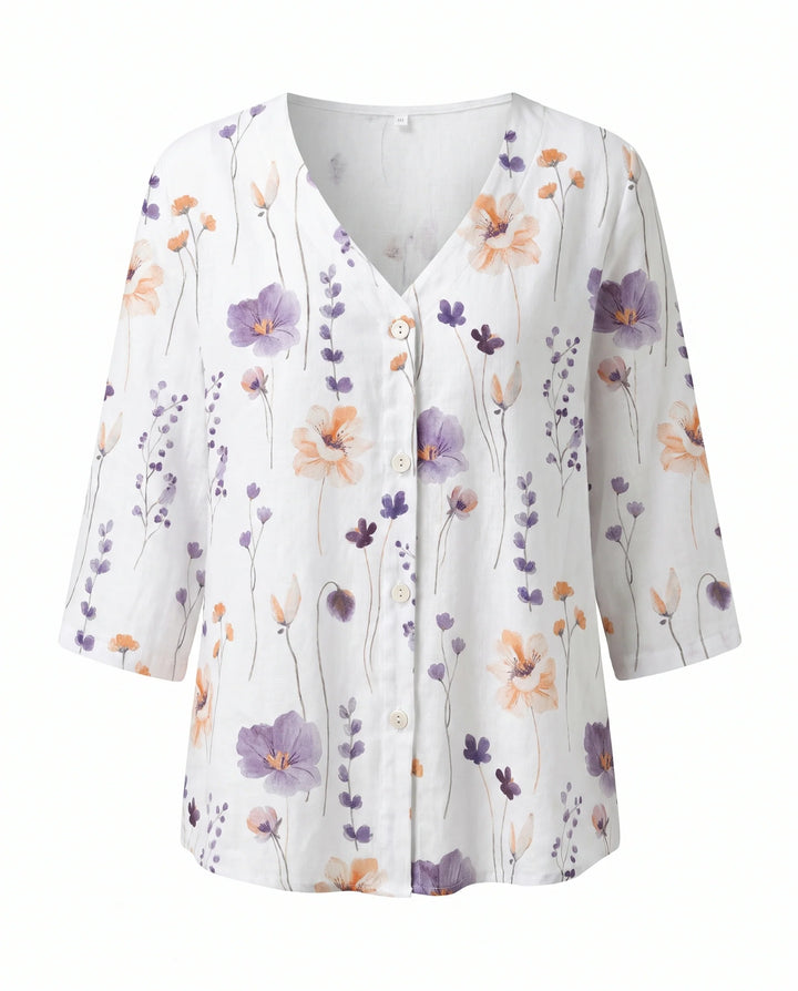 Floral V-neck blouse in soft fabric with three-quarter sleeves and casual silhouette.
