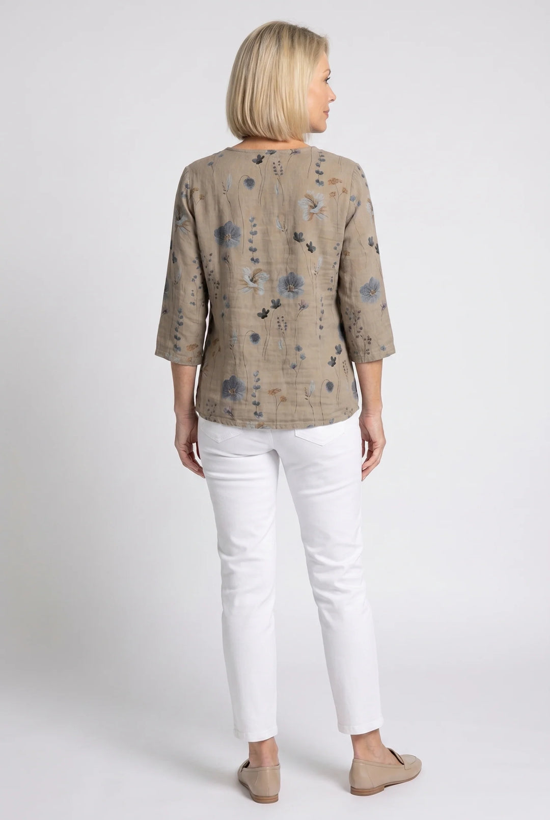 Button-front floral blouse in taupe with soft drape and relaxed silhouette.
