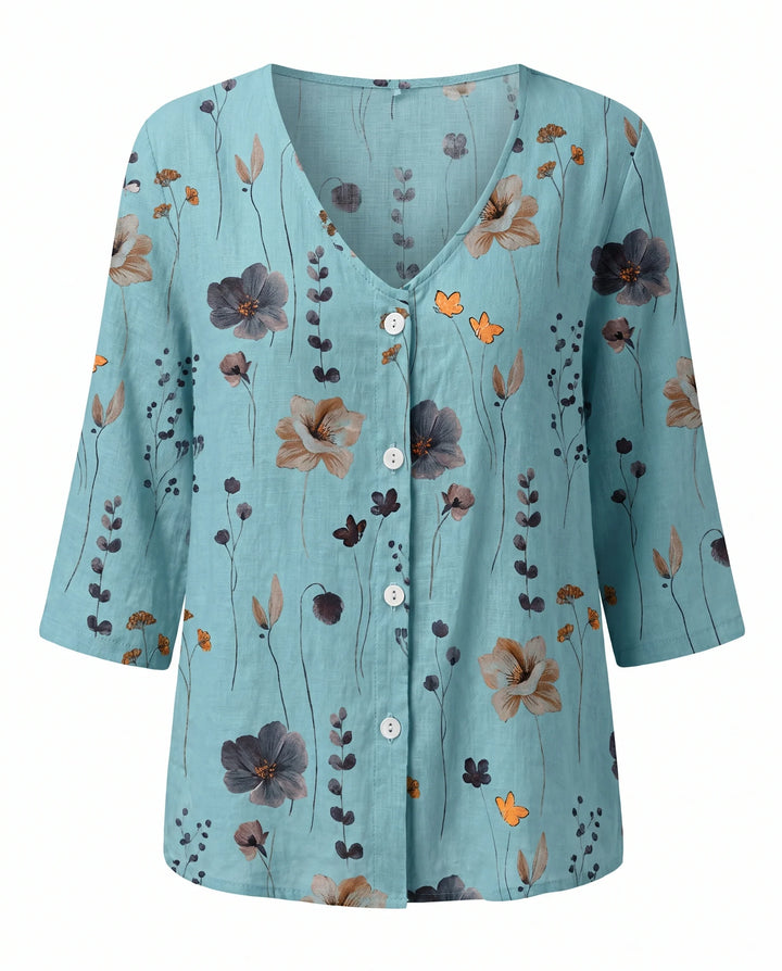 Relaxed floral print blouse with V-neck and three-quarter sleeves in neutral tone.