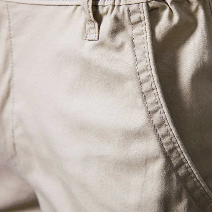 Detail of cuffed hem and smooth woven fabric on men's casual chino shorts