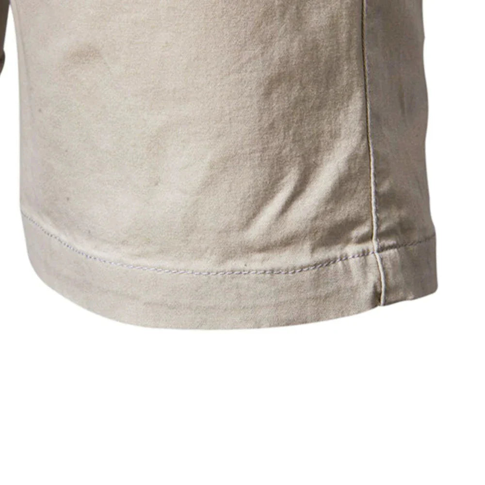 Flat lay of men's cuffed chino shorts showing clean tailored design and rolled hem