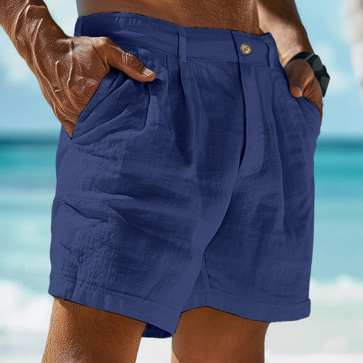 Side view of men's pleated chino shorts displaying structured fabric and tailored silhouette