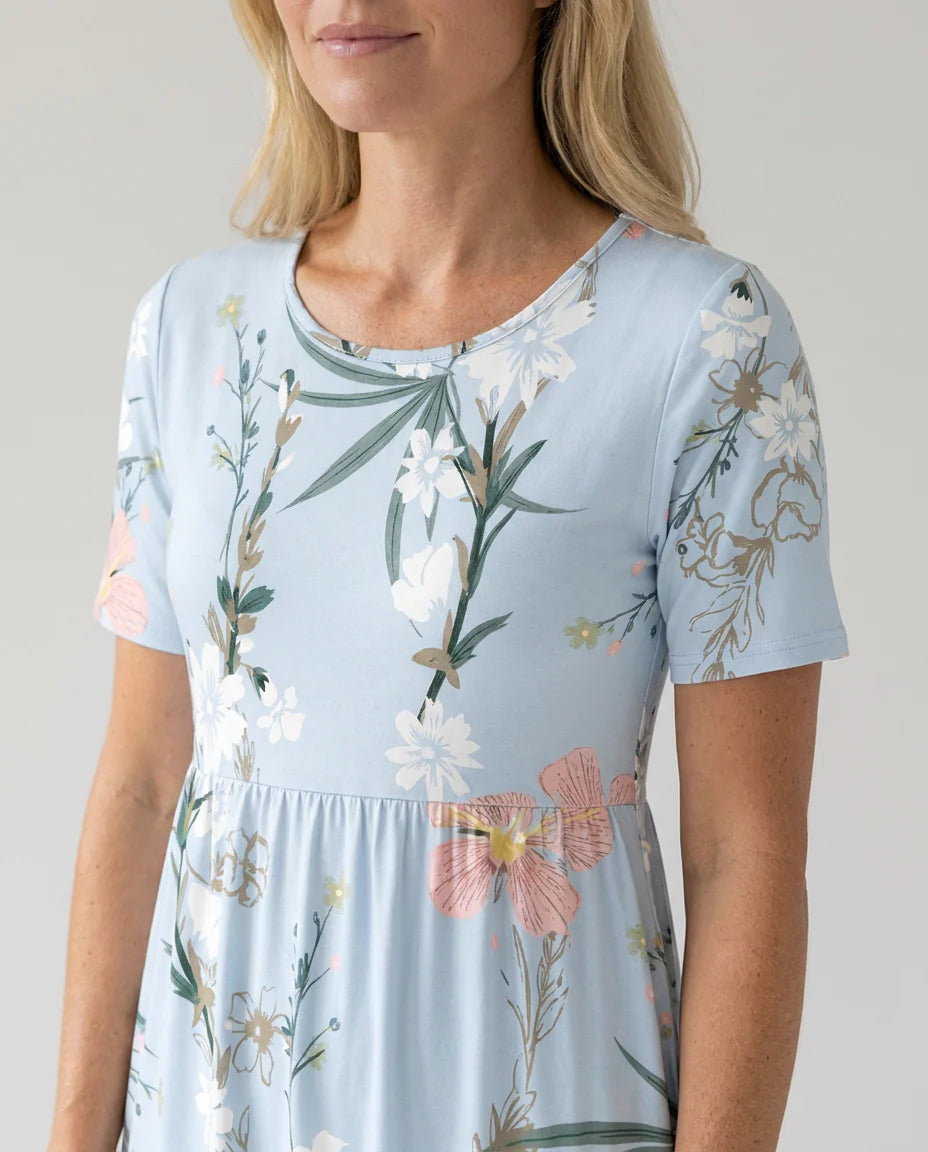 Side view of A-line floral midi dress with gathered waist and short sleeves