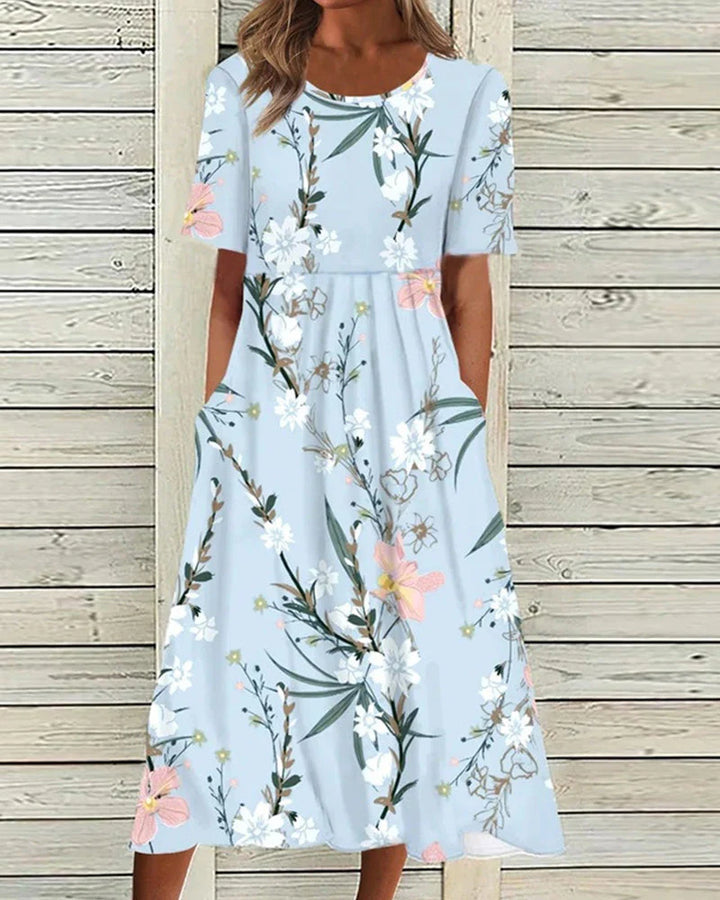 Close-up of gathered waist detail on floral midi dress with smooth fabric finish