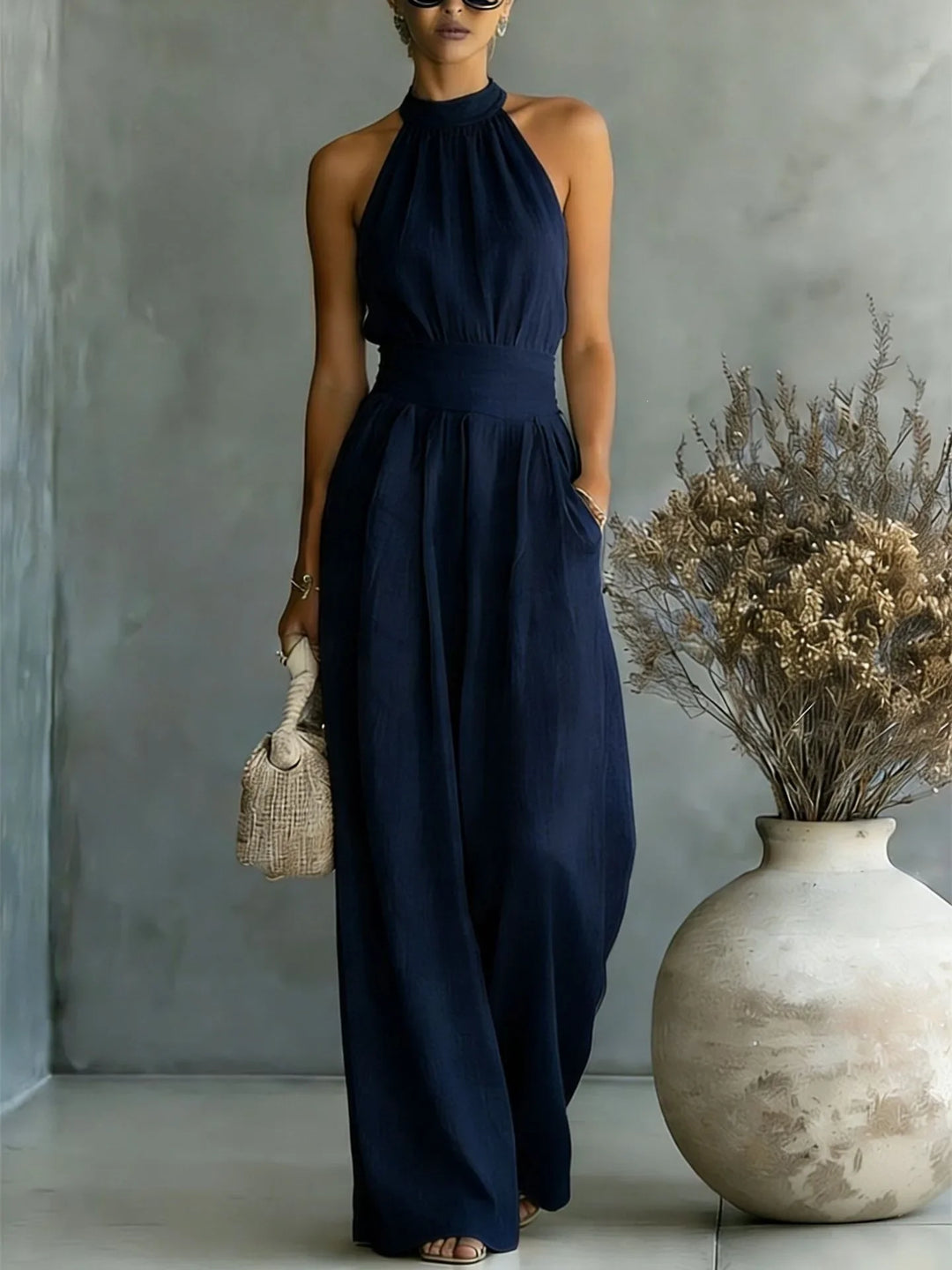 Side view of halter wide leg jumpsuit showing gathered neckline and relaxed wide leg fit