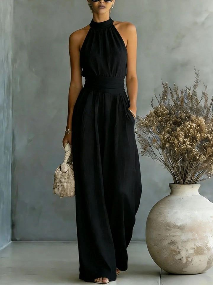 Back detail of halter wide leg jumpsuit featuring open shoulders and flowing wide leg pants