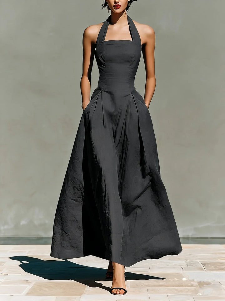 Model wearing halter maxi dress showing movement and drape of full skirt