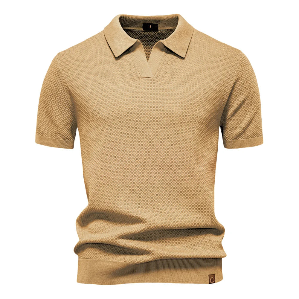 Detail of ribbed cuffs and hem on men's textured knit polo shirt
