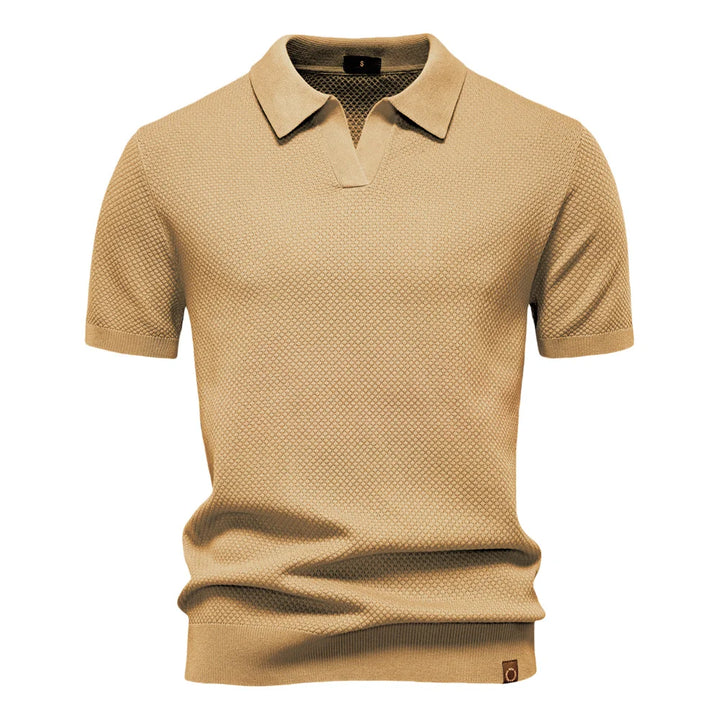 Detail of ribbed cuffs and hem on men's textured knit polo shirt