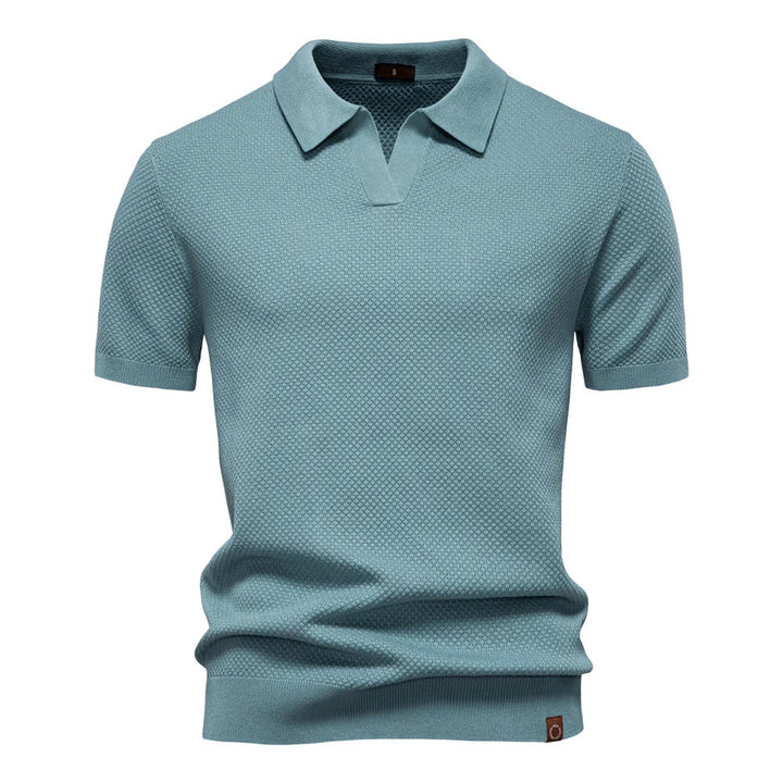 Men's knit polo shirt showing textured solid pattern and regular fit silhouette