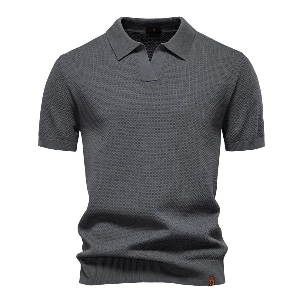 Side angle of men's short-sleeve knit polo with classic collar and ribbed cuffs