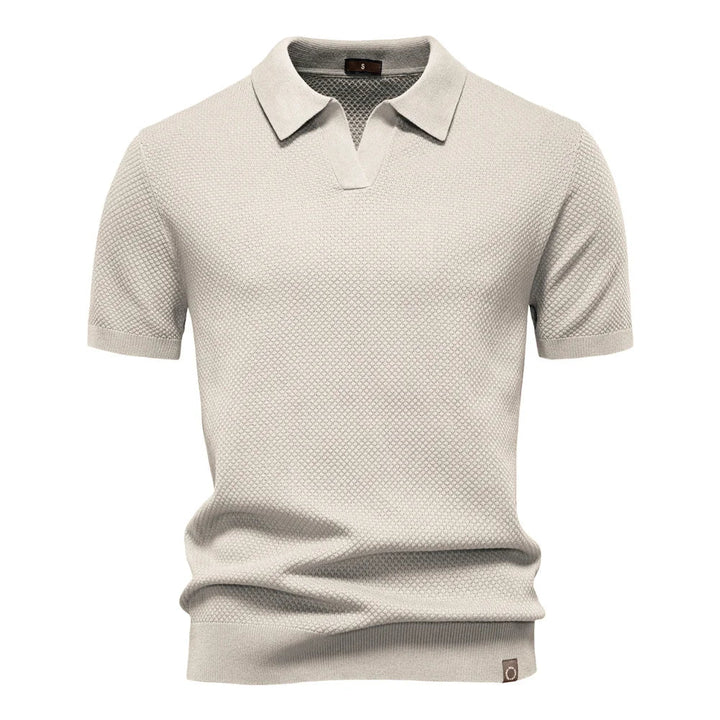 Back view of men's short-sleeve knit polo with all-over textured pattern