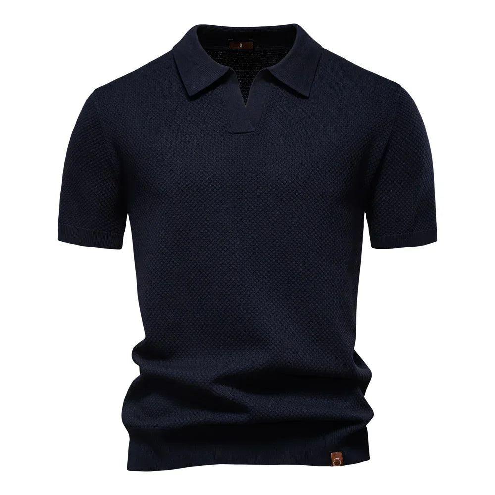 Men's textured knit polo shirt in dark gray showing structured fabric drape