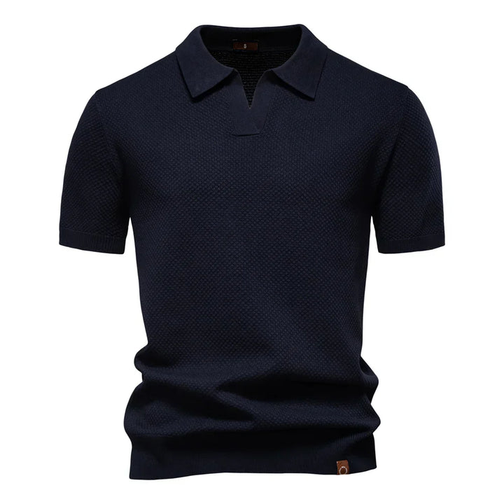 Men's textured knit polo shirt in dark gray showing structured fabric drape