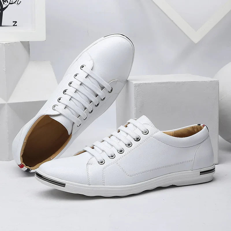 Men's low-top sneakers in white with lace-up closure and smooth finish displayed on geometric blocks